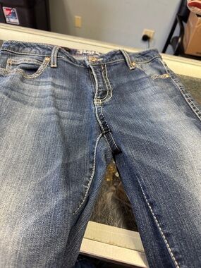 Wrangler Rock 47 Faded Blue Denim Jeans with Contrast Stitching